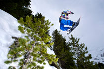 Snowboarder jumping by Ross Woodhall