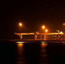 the industrial port at night under floodlights by Serhii Zhukovskyi