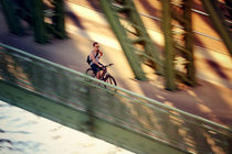 Cyclist cross a bridge by marunga