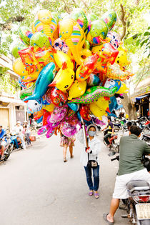 A balloon saleswoman at Hoi An Market. by Tom Hanslien