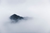 Peak in the clouds. by Tom Hanslien