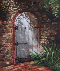 Decorative door in archway set in stone wall surrounded by plants von Martin  Davey