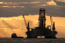 offshore rig at dawn by Bradford Martin