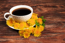 Coffee mug with flowers on wooden background  von larisa-koshkina