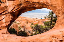 Two hikers at Double-O-Arch in Arches National Park, Utah, USA. by Johannes Elze
