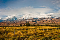 Snowy mountains covered by clouds by Johannes Elze