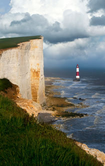 White cliffs and red-white striped lightouse in the sea by Jarek Blaminsky