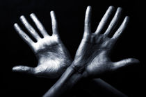hand in a silver paint isolated on black background von Igor Korionov