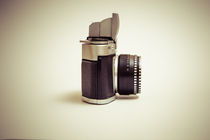 Old film camera with lens macro shot  by Peter-André Sobota
