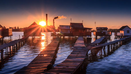 Sunset-fishing-houses-on-a-lake-in-bokod