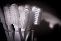 Toothbrushes in a glass by Gema Ibarra