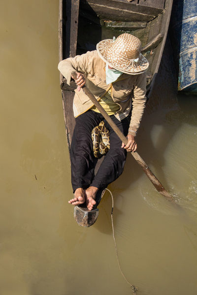 Asia-cambodia-woman-with-snake-on-boat-vietnam
