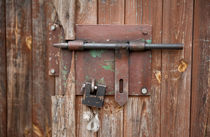 sliding bolt unlocked and padlock by Arletta Cwalina