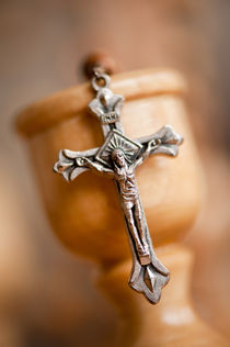 Cross on candlestick blurred rosary by Arletta Cwalina