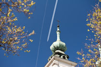 Aeroplane contrails and cross on turret by Arletta Cwalina