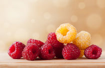 Fresh ripe red and golden raspberry by Arletta Cwalina