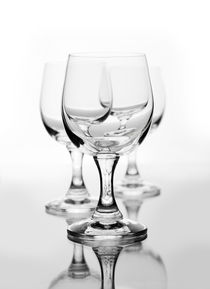 Three empty wine glasses on white by Arletta Cwalina