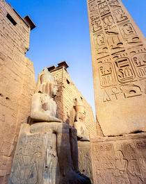 the gateway to Luxor temple Egypt with colossi of Ramses II by Sean Burke