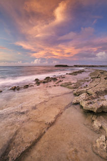 Rocky coast on the island of Curaçao at sunset by Sara Winter