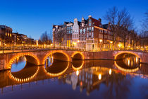 Bridges over canals in Amsterdam at night by Sara Winter
