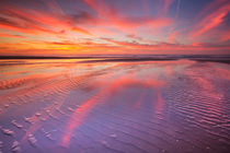 Beautiful sunset and reflections on the beach at low tide by Sara Winter