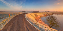 Typical Dutch landscape with a dike, in winter at sunrise by Sara Winter