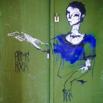 Woman in Blue Painting Graffity on green Door by Ralf Ketterlinus
