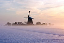 Traditional windmill in snowy landscape in the Netherlands by nilaya