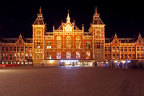 Medieval central station in Amsterdam Netherlands by night by nilaya