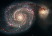 The whirlpool galaxy (M51) and companion galaxy. by Stocktrek Images