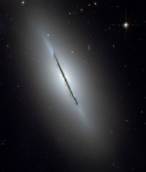 Disk galaxy NGC 5866. by Stocktrek Images