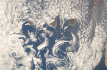 Cloud vortices in the area of the Canary Islands. by Stocktrek Images