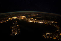 Nighttime panorama showing city lights of Europe. by Stocktrek Images