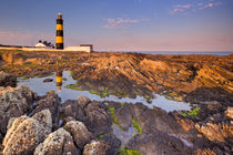 Lighthouse in Northern Ireland at sunset by Sara Winter
