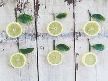 fresh lemons with green leaves on the wood by timla