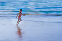 Girl running on the beach at water line by Sharon Yanai