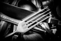 Black and white photo of mixed silver forks, spoons and knives by maxal-tamor