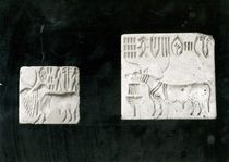 Two decorated seals depicting a zebu and a bull by Harappan