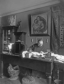 French composer Jules Massenet sitting at his desk by Dornac