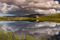 Huts on lake in landscape of Norway by Bastian Linder