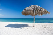 Caribbean beach with parasol in Cuba by Bastian Linder