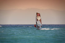 Windsurfing during sunset on sea by Bastian Linder