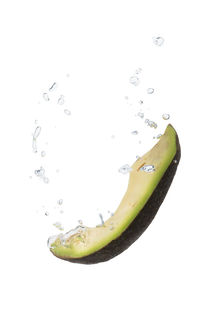 Avocado in water with air bubbles by Bastian Linder