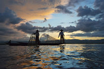 Intha fisherman rowing boat with leg at sunset on Inle Lake,... by Danita Delimont