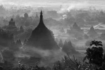 Ancient temples and pagodas in the jungle rising above sunse... by Danita Delimont