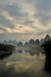 Sunset along the Li River near Yangshuo, China with the laye... by Danita Delimont