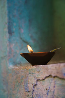 Lamp in a little shrine outside traditional house, Varanasi, India by Danita Delimont