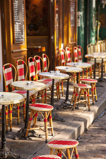 Cafe tables and chairs waiting for customers in Place du Ter... by Danita Delimont