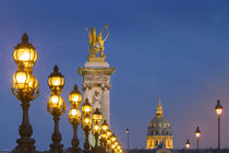 Row of lampposts along Pont Alexandre III with dome of Hotel... by Danita Delimont
