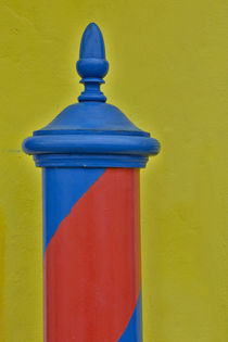 Red and blue painted and stripped pole with yellow home as b... von Danita Delimont